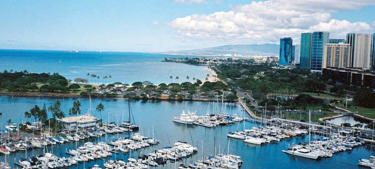 Aerial view of the Ala Wai Harbor packed with boats, with Waikiki and the Honolulu skyline beyond, Oahu, Hawaii